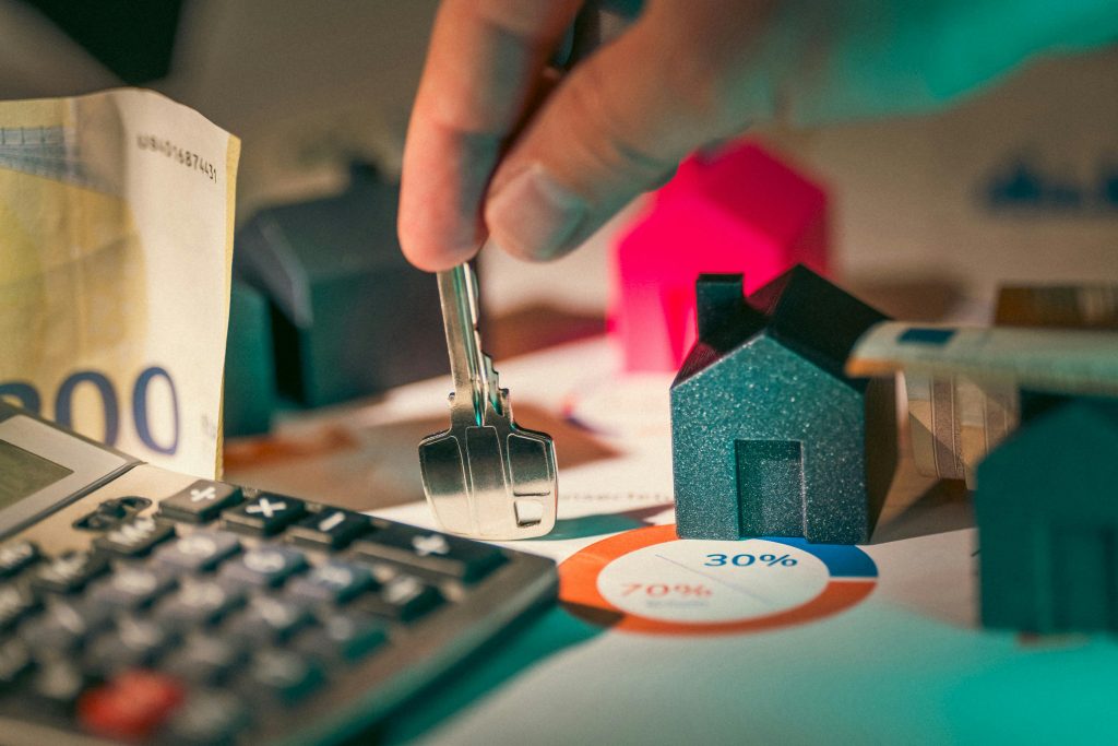 pexels-photo-27960363-27960363 A close-up of real estate financial planning with keys, calculator, and money.